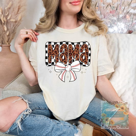 Woman wearing a white t-shirt with 'Mama' in leopard print and a bow graphic.